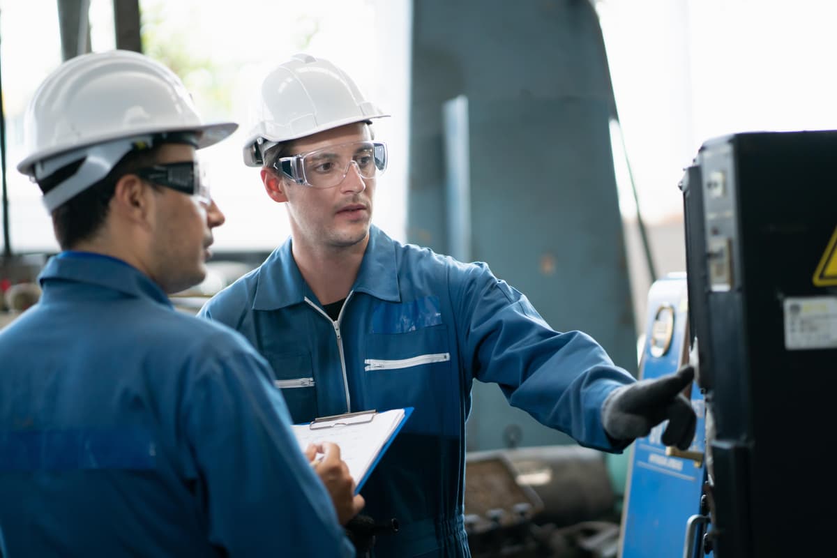 Factory workers collaborating in manufacturing environment