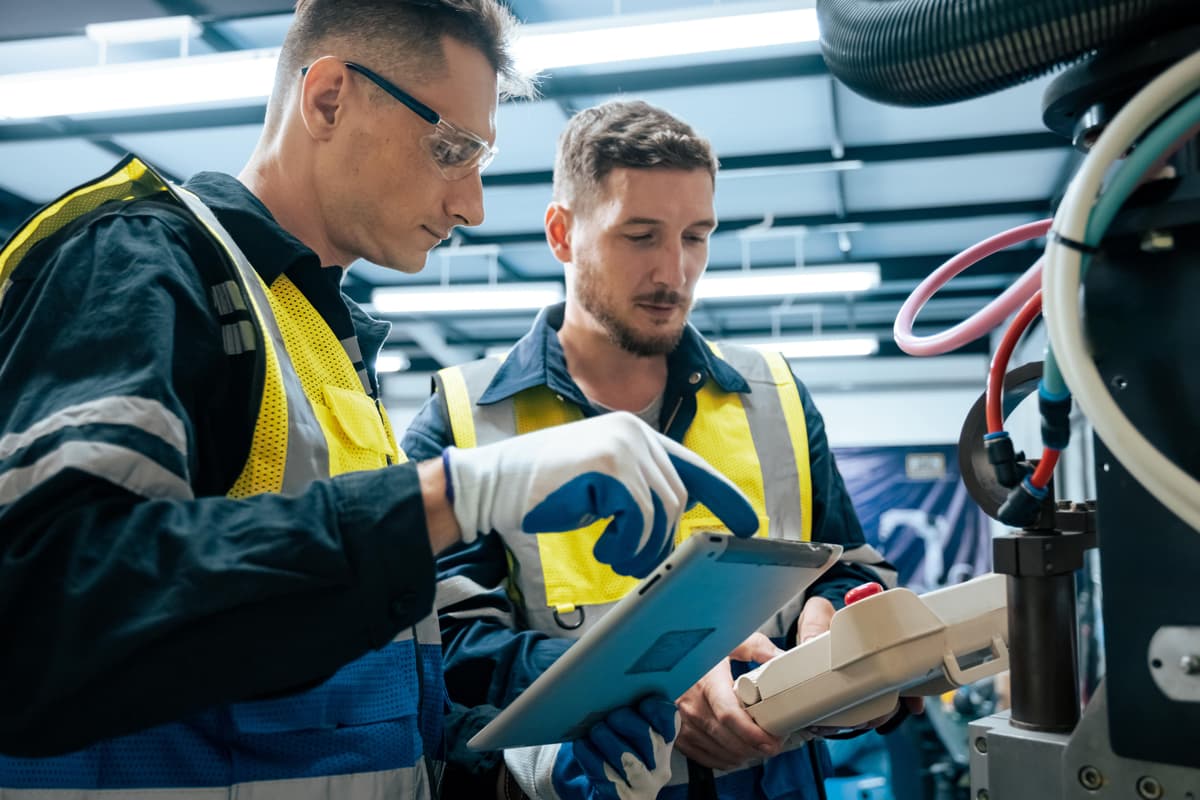 Factory workers collaborating in manufacturing environment
